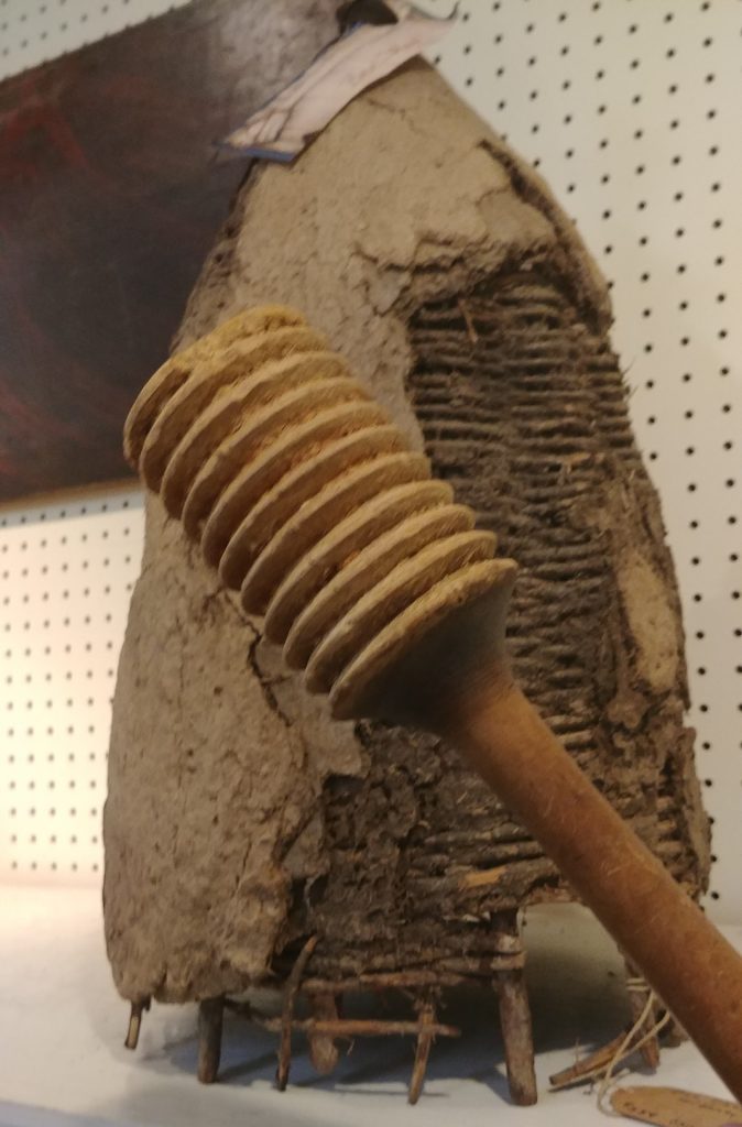 Old skep with large honey dipper