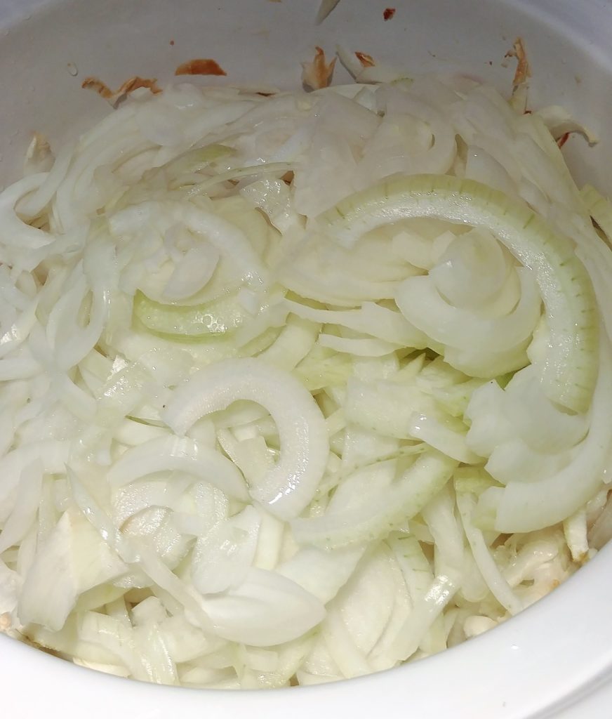 Start with a crock pot heaped to overflowing with sliced raw yellow onions